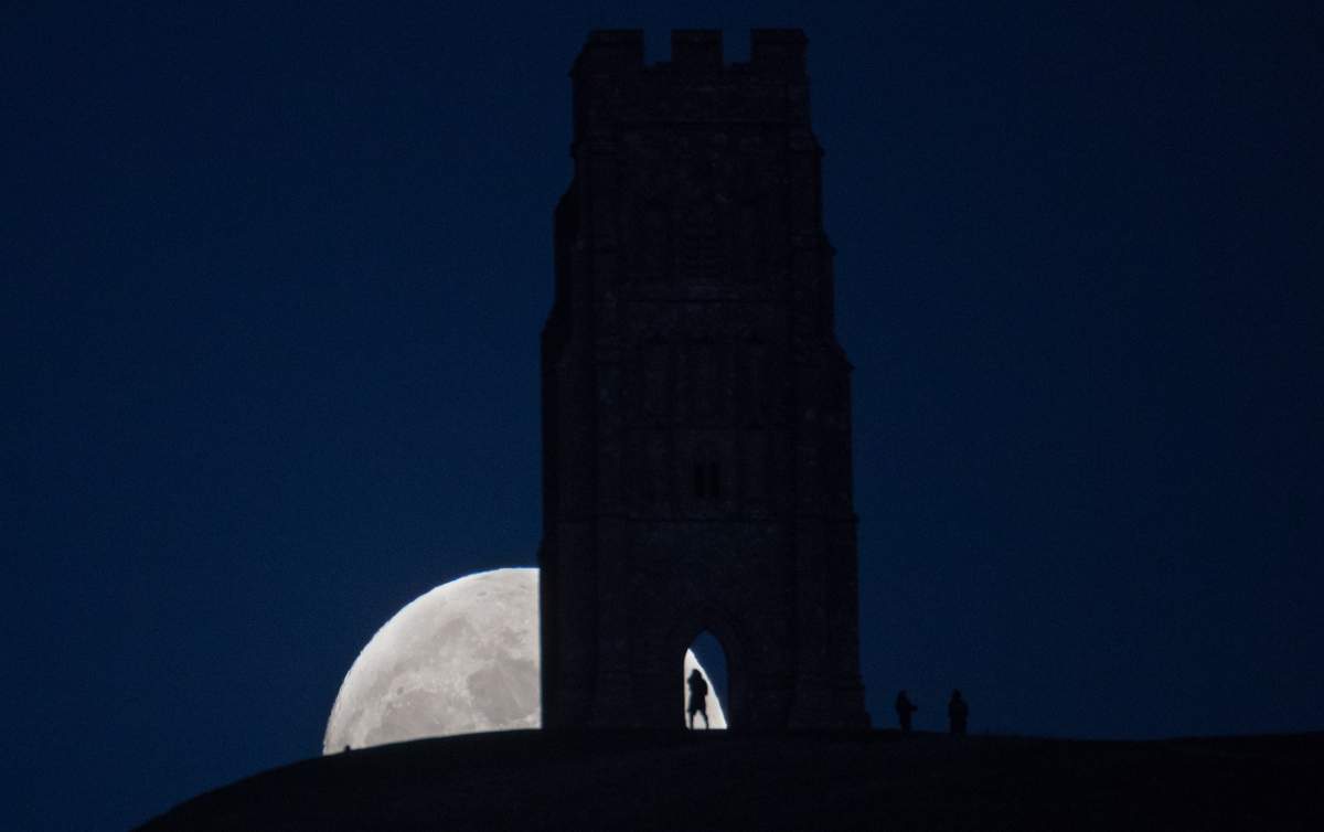A so-called wolf moon rises over Glastonbury Tor on Jan. 11, 2017, in Somerset, England.