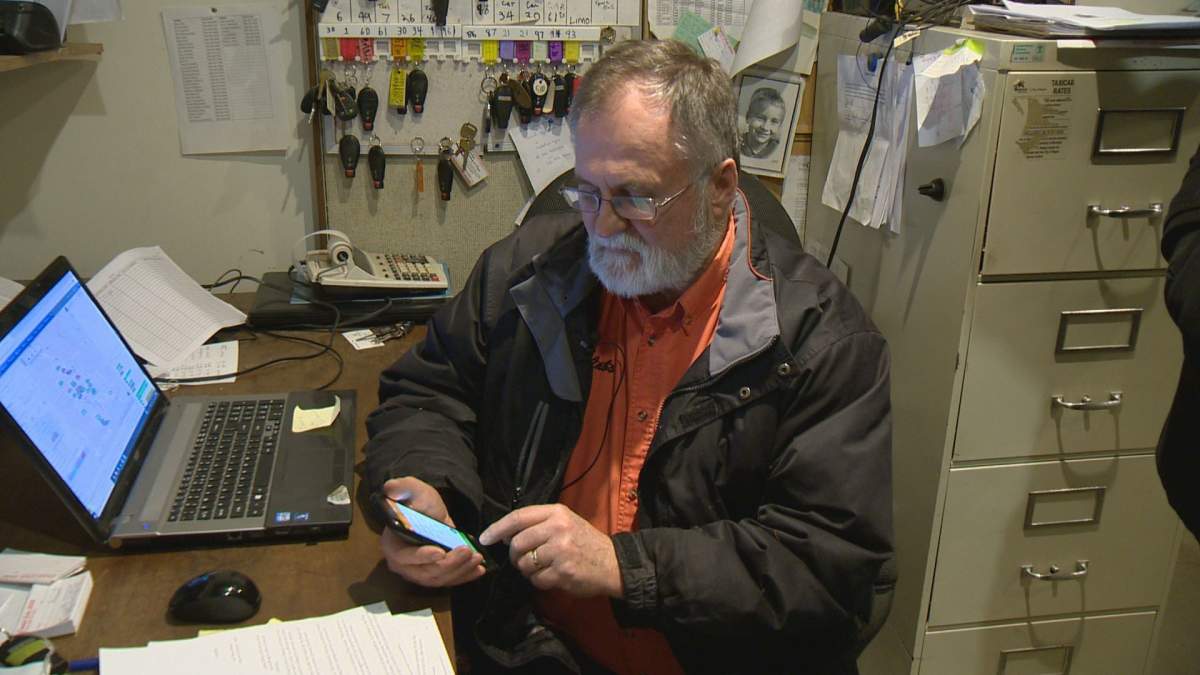 Capital Cabs owner Glen Sail demonstrates the taxi company’s app, which offers booking and real time arrival tracking.