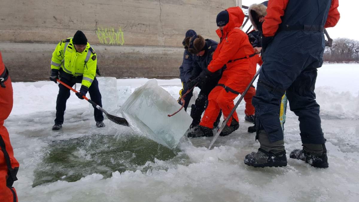 RCMP and Winnipeg police work together to search for evidence on the Red River.