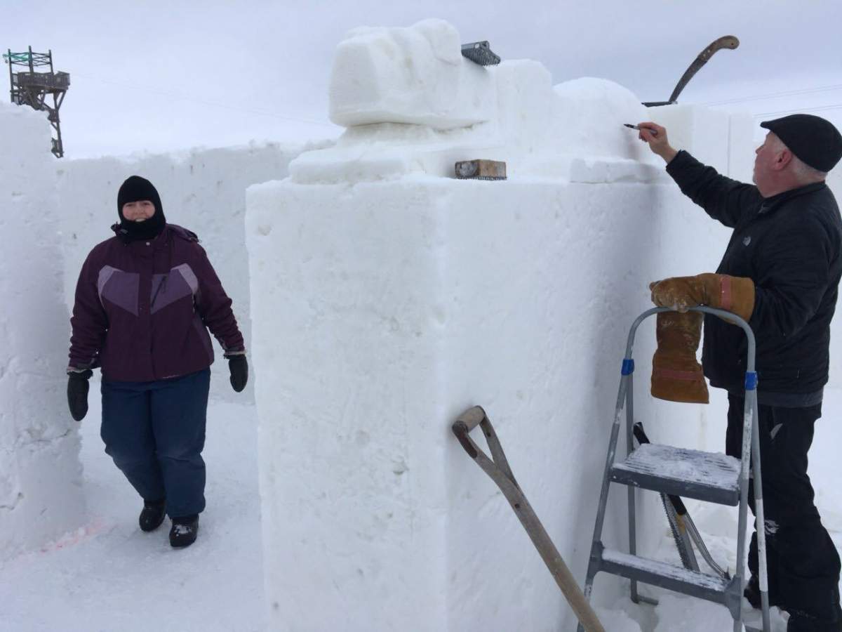 Snow maze employees putting some final touches on the walls.