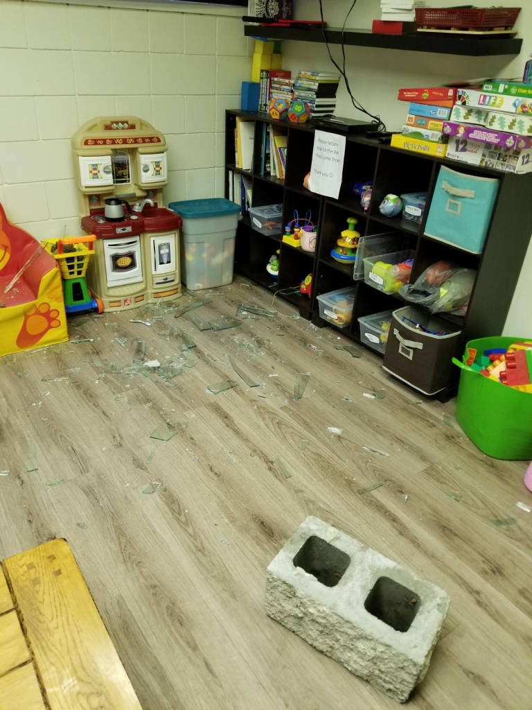 A concrete block can be seen on the floor after it was thrown threw a window at the The Ki-Low-Na Friendship Society early Monday morning.