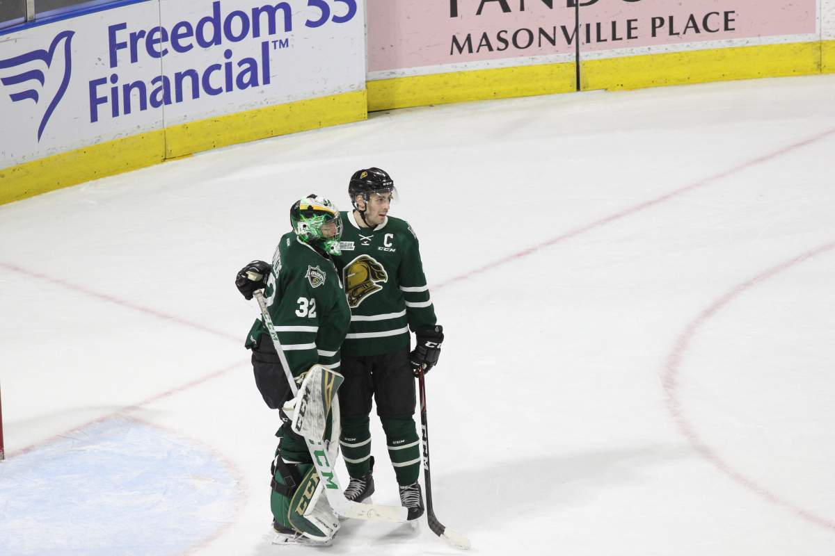 London, Ont. - Knights captain Evan Bouchard congratulates London goaltender Joseph Raaymakers on a shutout against Windsor in a 7-0 London victory at Budweiser Gardens on January 25, 2019.