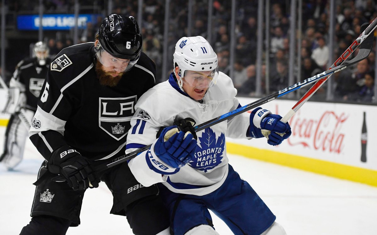 The Toronto Maple Leafs have acquired defenceman Jake Muzzin, left, in a trade with the Los Angeles Kings.