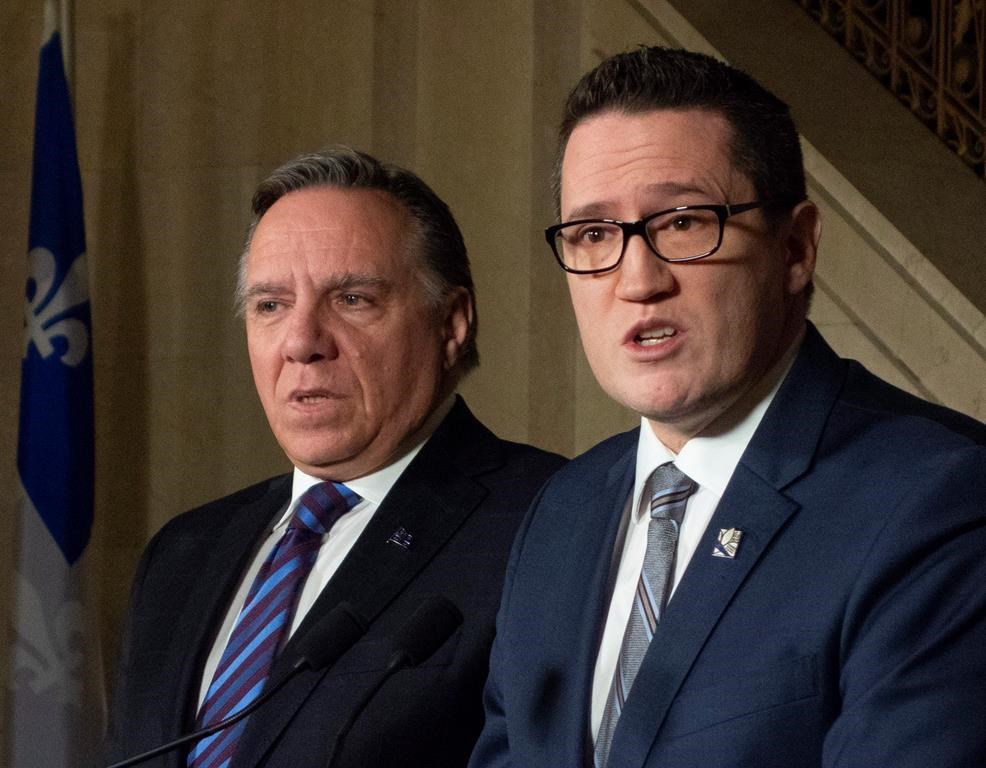 The newly appointed minister Benoit Charette, right, is pictured next to Quebec Premier Legault. Legault and his cabinet have continuously denied to acknowledge that systemic racism exists in the province.