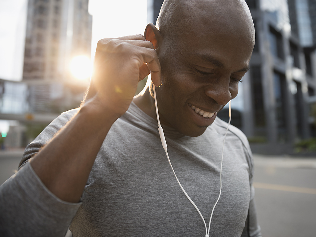 A man heads out for a run with his headphones in.