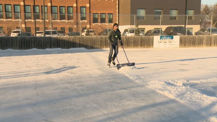 John Holgate clearing snow at the City Park Outdoor Rink.