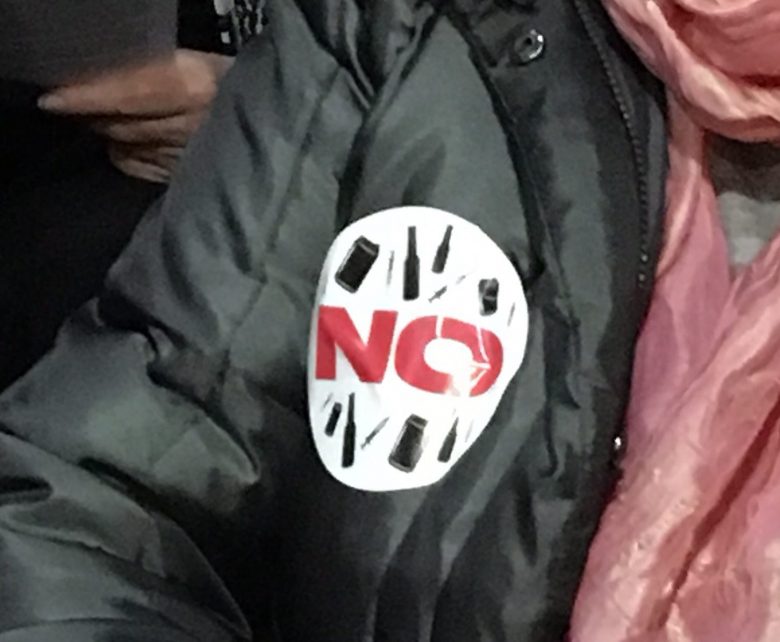A “no” sticker worn by a person attending a public meeting at Kelowna city hall on Thursday night.