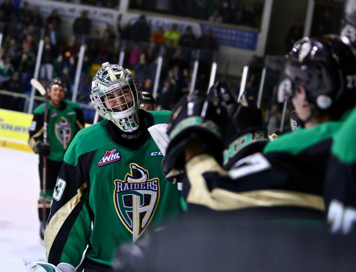 Prince Albert goalie Ian Scott gets high-fives from the Raiders’ bench.