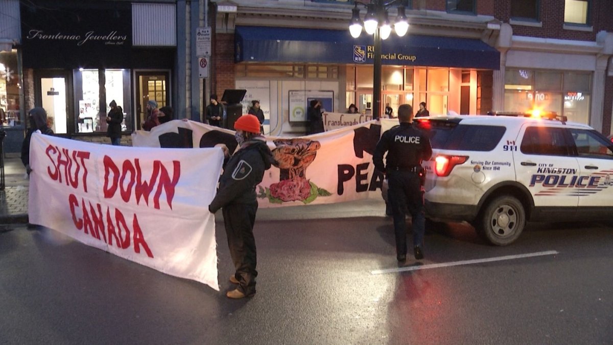 A group of protesters gathered on Princess Street in Kingston to stand in solidarity with a group of Indigenous people arrested in B.C. while fighting the construction of a pipeline project.