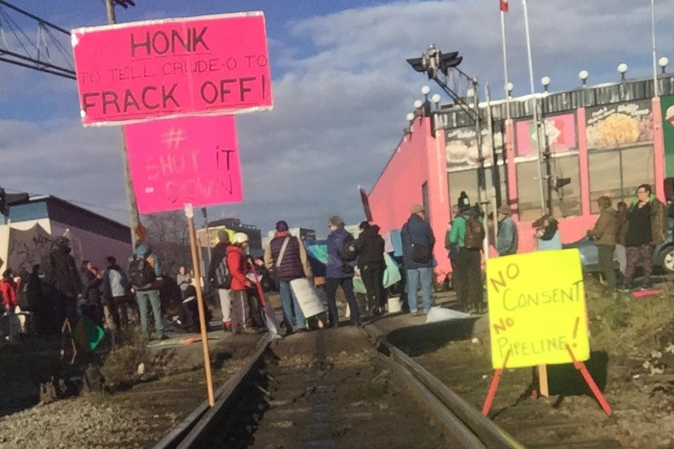 A group of demonstrators blocks the CN Rail crossing at Venables Street and Glen Drive on Wednesday.