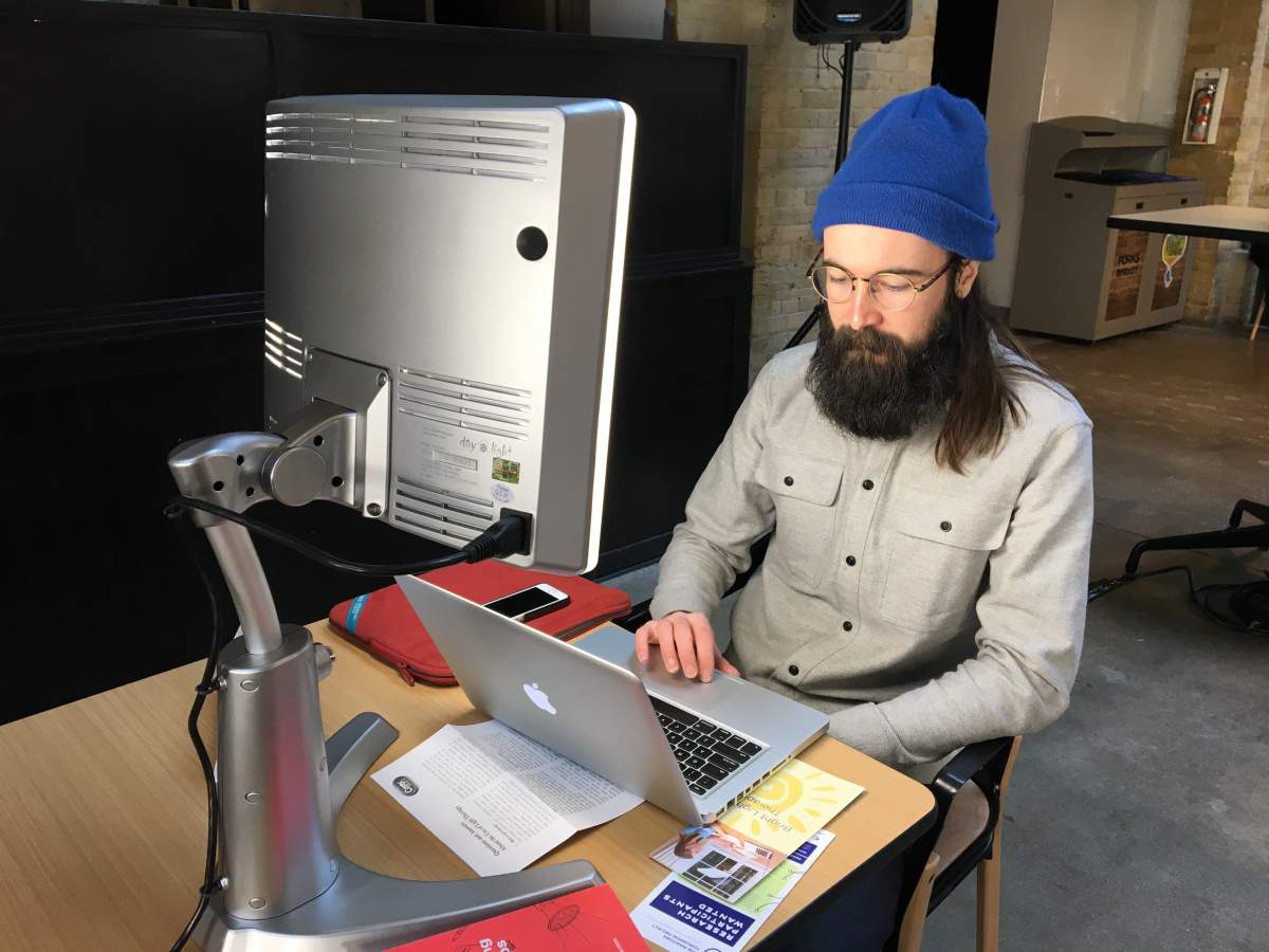 A man using a SAD light.