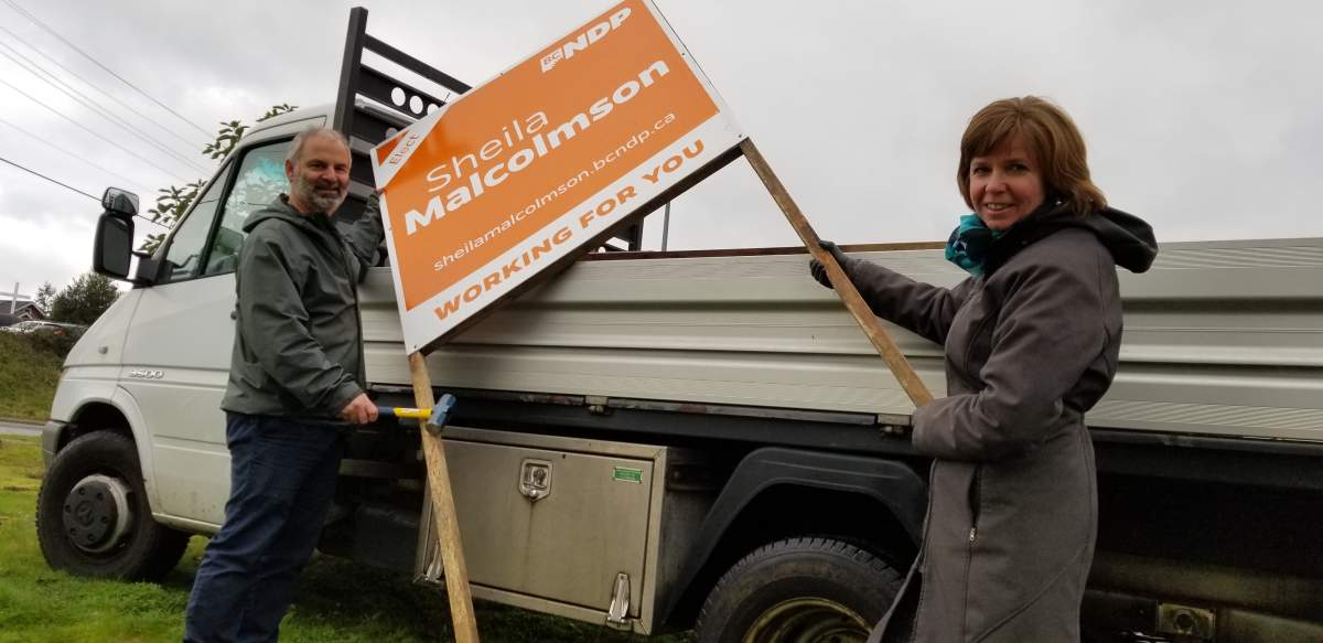 NDP byelection candidate Sheila Malcolmson helps put up campaign sign in Nanaimo on January 2, 2019.