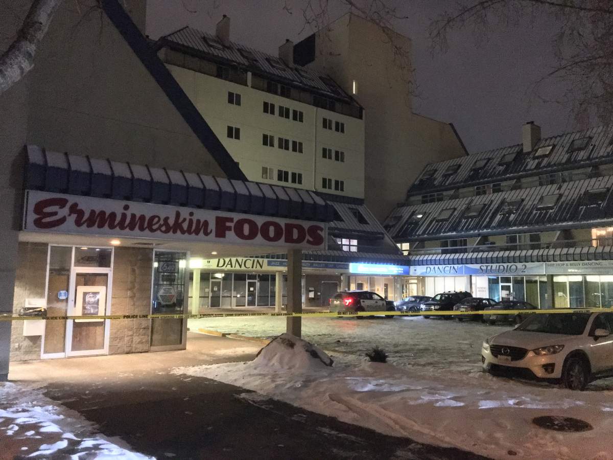 Police tape surrounds an area outside a southwest Edmonton apartment building.