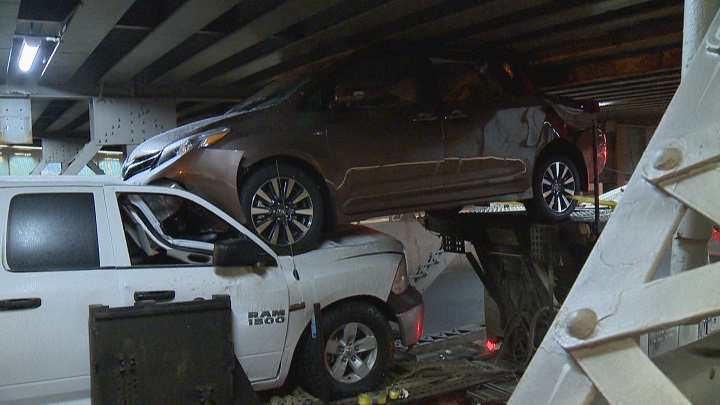A transport truck carrying multiple vehicles ended up wedged under a Calgary underpass on Wednesday, Jan. 16, 2019.