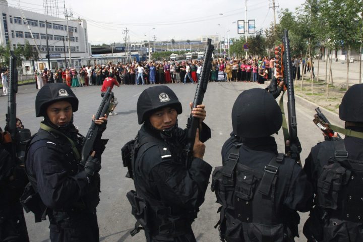 Heavily-armed special police officers face off a crowd of Uighur residents after they staged a protest in Urumqi, capital of northwest China’s Xinjiang Uygur Autonomous Region, Tuesday, July 7 , 2009.