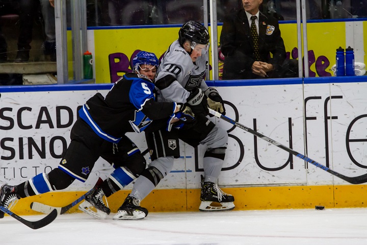 Jonathan Krahn of the Salmon Arm Silverbacks, right, holds off Eric Linell of the Penticton Vees during BCHL action in Penticton on Friday night.