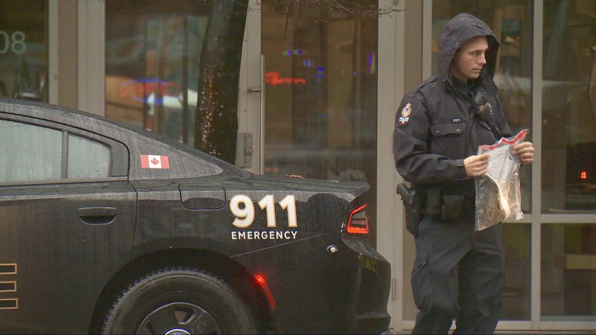 VPD officers at the scene of an incident in which a woman fell four storeys while allegedly trying to evade police.