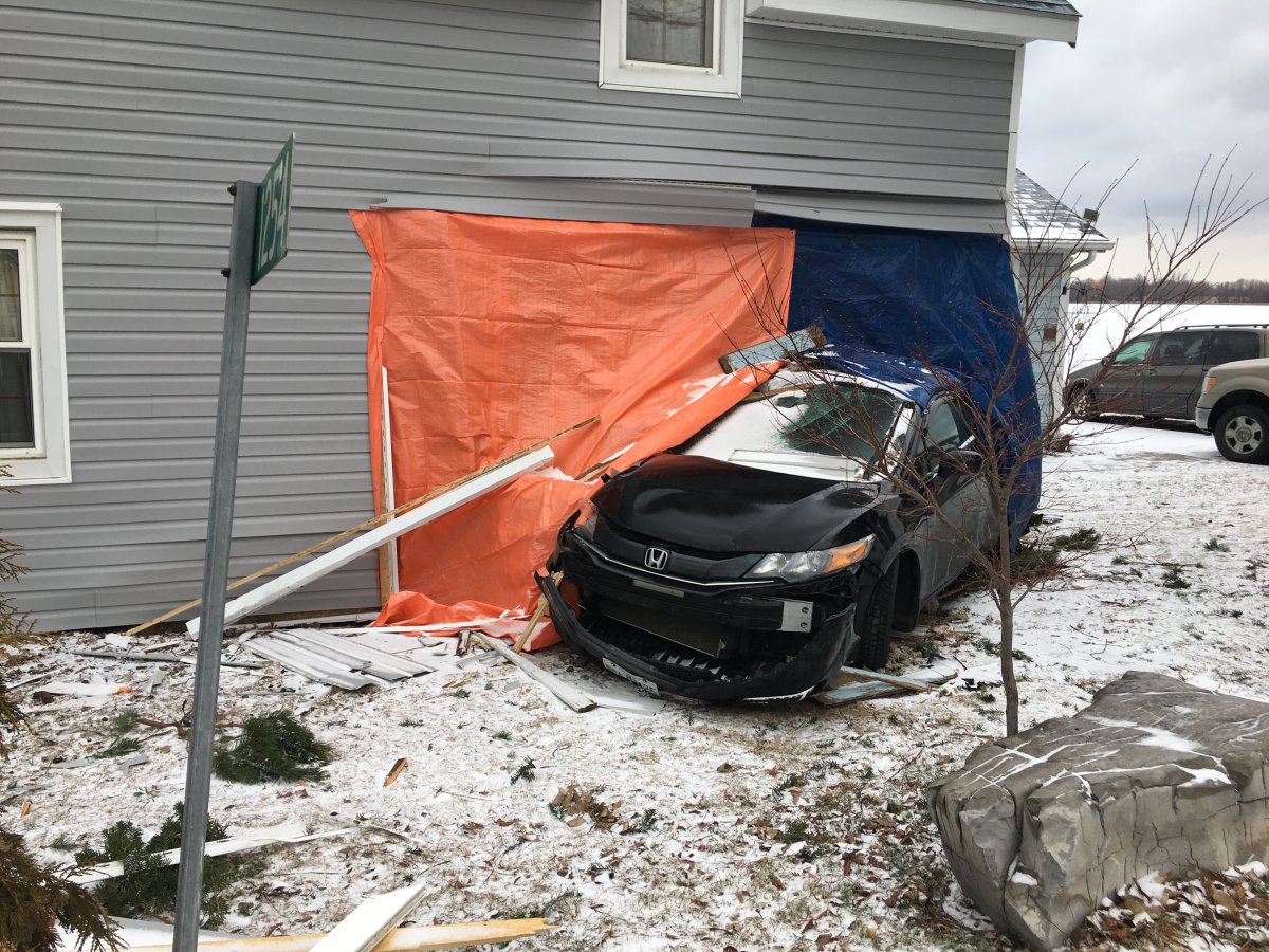 A woman was charged with impaired driving after she allegedly drove her car into a home on Wolfe Island, OPP say.