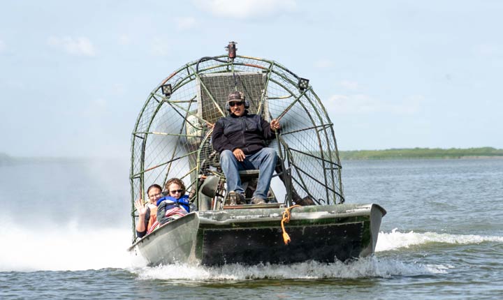 Project co-leader Gary Carriere (right) and USask assistant professor Lori Bradford (far left) examining sediment levels on the Cumberland House Delta in northern Saskatchewan.