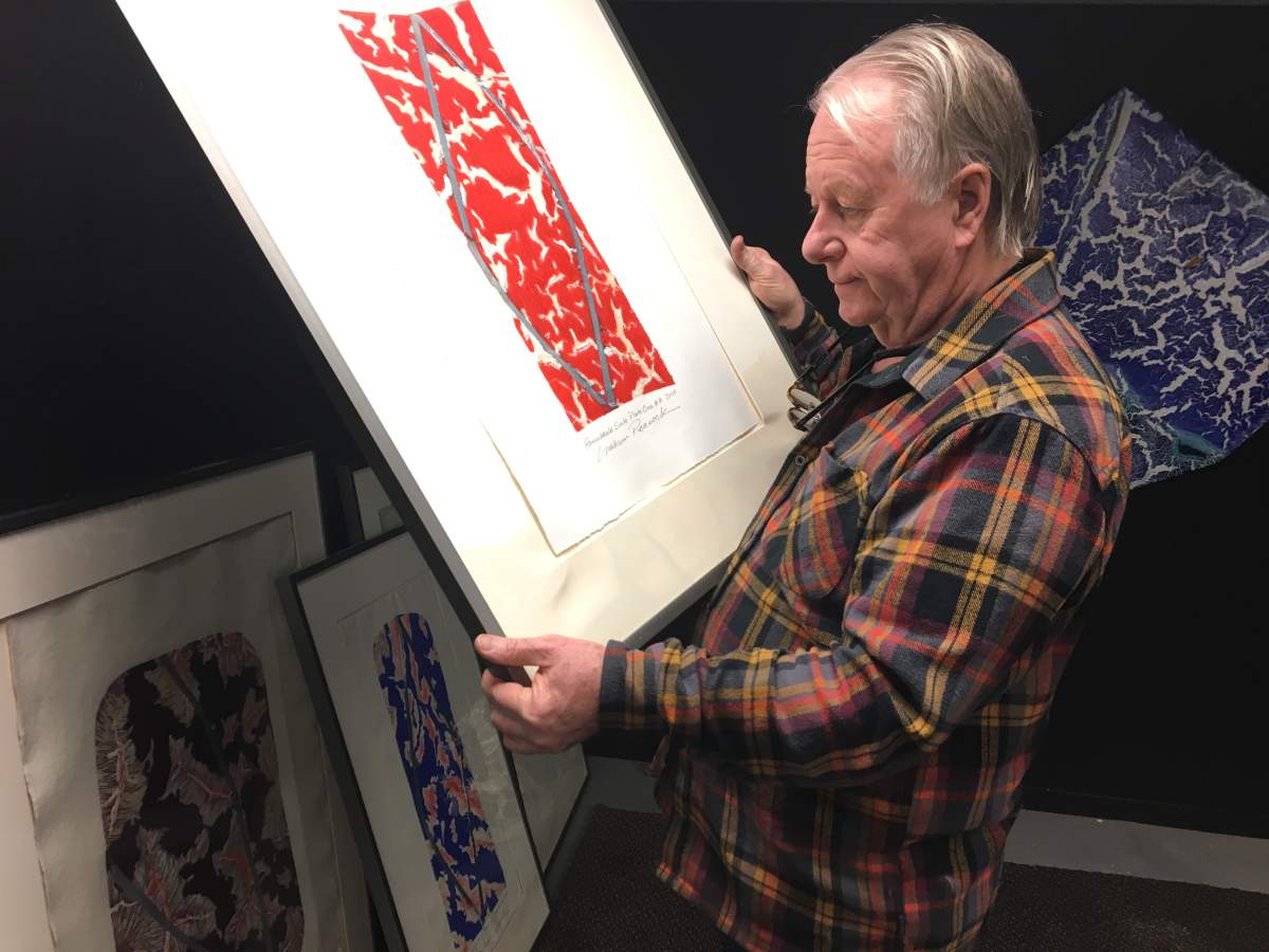 Artist Graham Peacock looks through his work after a flood in downtown Edmonton Feb. 16, 2019.