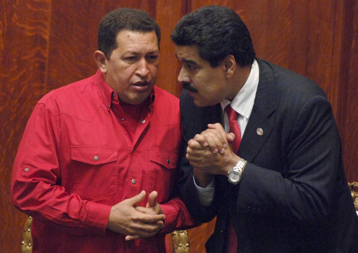 In this Dec. 18, 2007 file photo Venezuela’s President Hugo Chavez, talks to then Foreign Minister Nicolas Maduro in Montevideo, Uruguay.