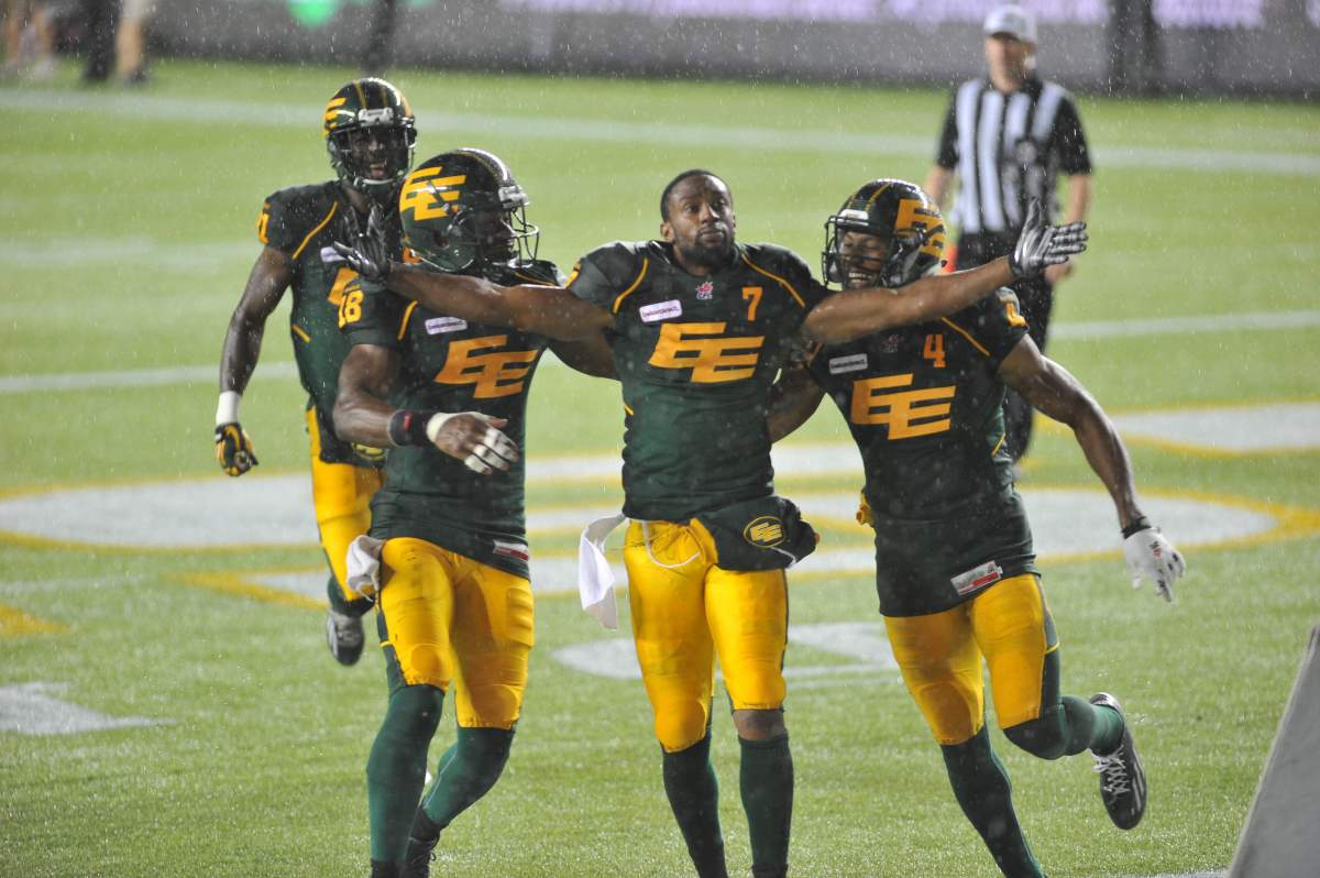 Edmonton Eskimos player # 7 (WR) Kenny Stafford celebrates his touchdown in the endzone as Eskimos players  player #18 ( SB) Cory Watson and Eskimos #4 (SB) Adarius Bowman celebrate with him during the 3rd quarter of CFL game action between the Edmonton Eskimo's and the Calgary Stampeders at Commonwealth stadium in EdmontonSaturday, Sept. 12 ,2015 .