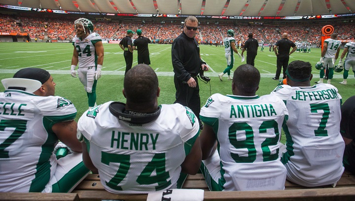 Saskatchewan Roughriders' head coach Chris Jones, centre, speaks to Eddie Steele, from left to right, Makana Henry, Tobi Antigha and Willie Jefferson on the bench during the second half of a CFL football game against the B.C. Lions in Vancouver, B.C., on  Aug. 5, 2017.