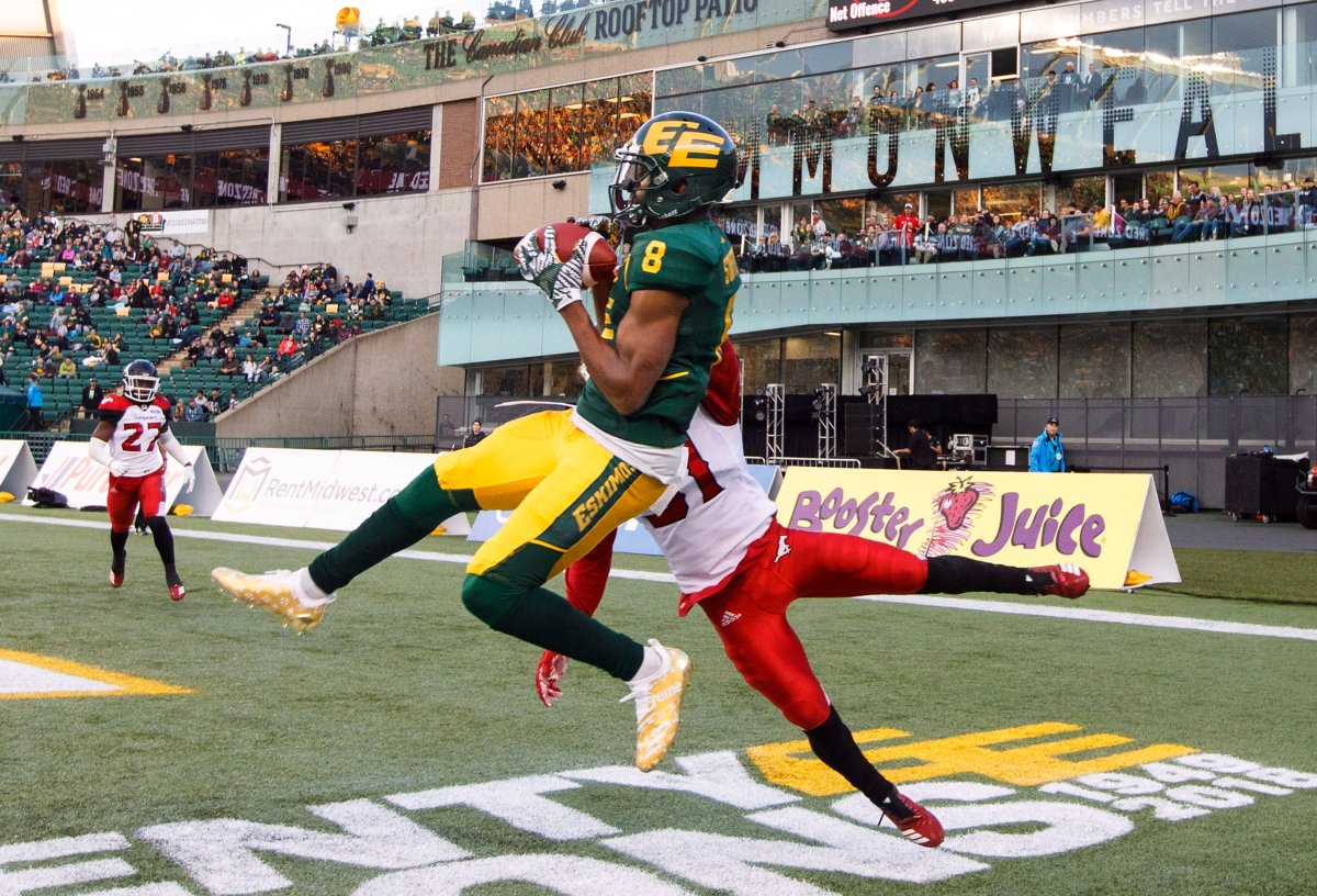 Calgary Stampeders Tre Roberson (31) tries to stop Edmonton Eskimos Kenny Stafford (8) as he makes the catch for the touchdown during first half CFL action in Edmonton, Alta., on Saturday Sept. 8, 2018. 