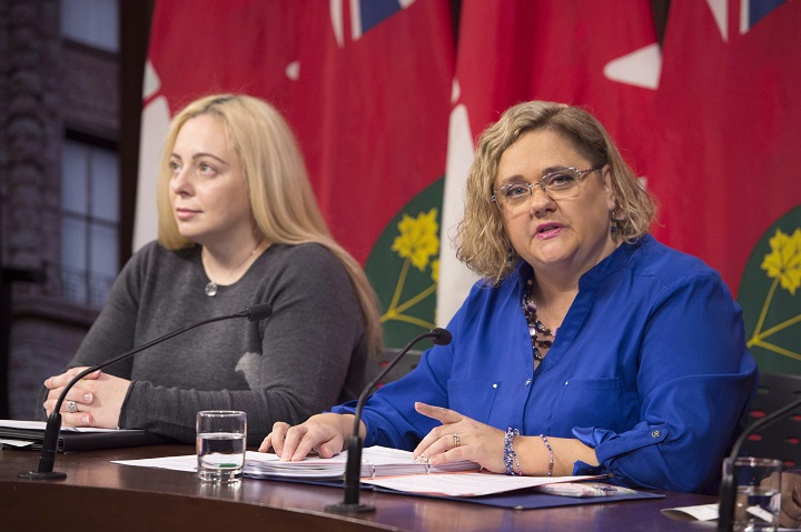 Laura Kirby-McIntosh (right), president of the Ontario Autism Coalition, speaks as autism parent Maria Galito listens in at a news conference at the Ontario Legislature in Toronto on Monday, November 12, 2018. THE CANADIAN PRESS/Frank Gunn.