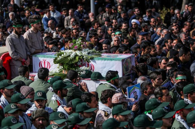 Members of Iran’s elite Revolutionary Guards, gather around the coffins of their fellow guards, who were killed by a suicide car bomb, during the funerals in Isfahan, Iran February 16, 2019.