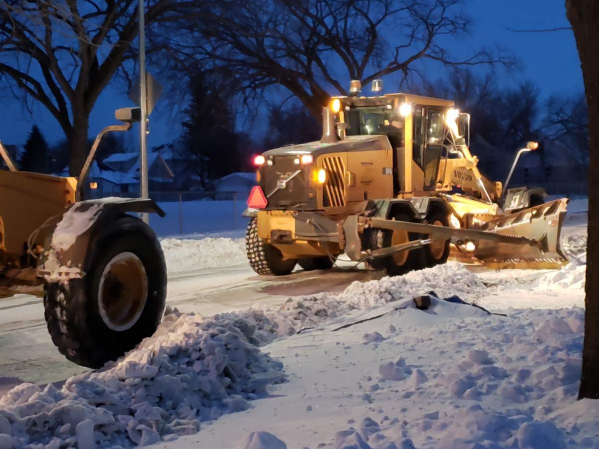 Snow clearing on a residential street in Winnipeg.