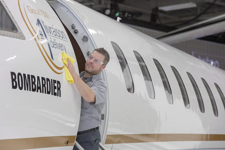 IN this Dec. 2018 file photo, Francis Masse shines up Bombardier's new jetliner, the Global 7500, the longest-range business jet in the world at the company's finishing plant in Montreal.