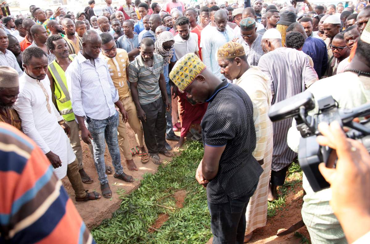 In this photo taken Friday, Jan. 18, 2019, Mourners bury the body of Ahmed Hussein-Suale investigative journalist, who was shot dead by gunmen on a motorbike on Wednesday night, in Accra, Ghana. The U.S. Embassy in Accra has condemned the murder of the Ghanaian investigative journalist who helped expose a high-ranking official at world soccer body FIFA as corrupt. 