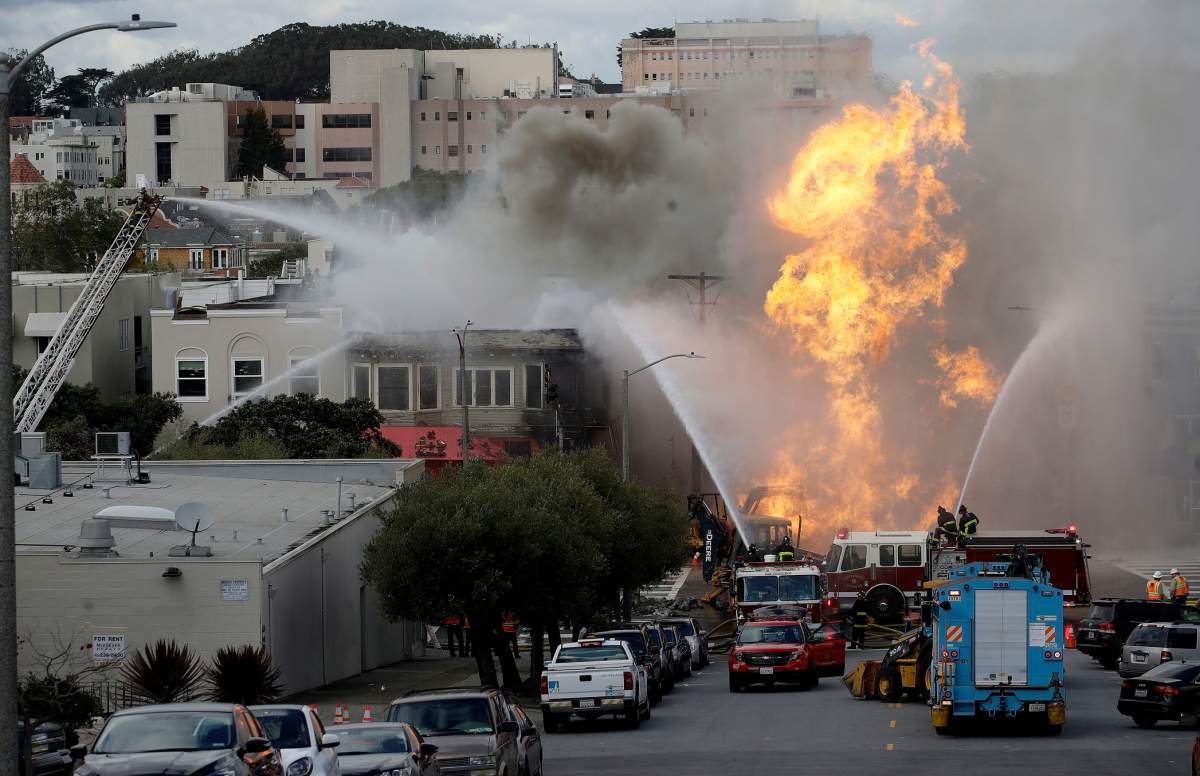 San Francisco firefighters battle a fire on Geary Boulevard in San Francisco, Wednesday, Feb. 6, 2019.