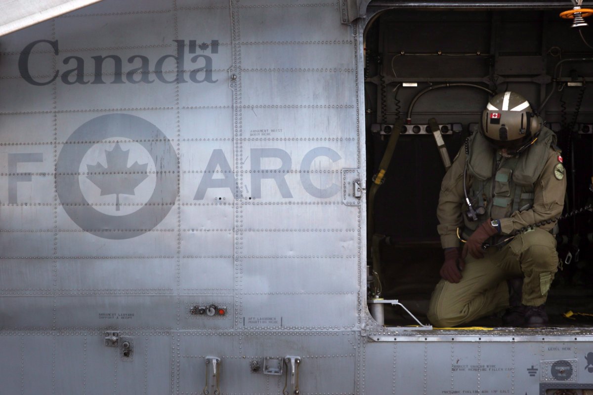 A RCAF crew member prepares for takeoff aboard the CH-124 Sea King helicopter at 443 Maritime Helicopter Squadron in Saanich, B.C., on Tuesday, November 27, 2018. 