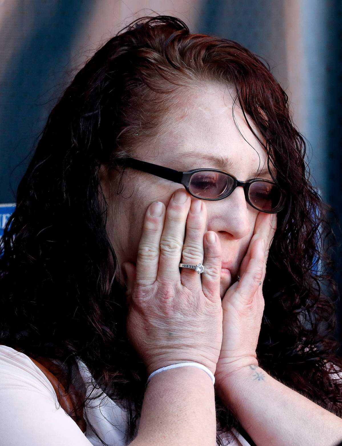 Anya Chapman wipes away tears as attorney Marc J. Victor speaks to the media concerning Chapman’s husband, Johnny Wheatcroft, Monday, Feb. 11, 2019, in Chandler, Ariz. Victor has filed a lawsuit on behalf of Wheatcroft claiming the Glendale, Ariz., police department used excessive force against Wheatcroft during his arrest in 2017.