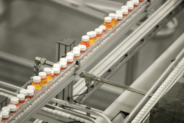 In this July 10, 2018, file photo bottles of medicine ride on a belt at the Express Scripts mail-in pharmacy warehouse in Florence, N.J. 