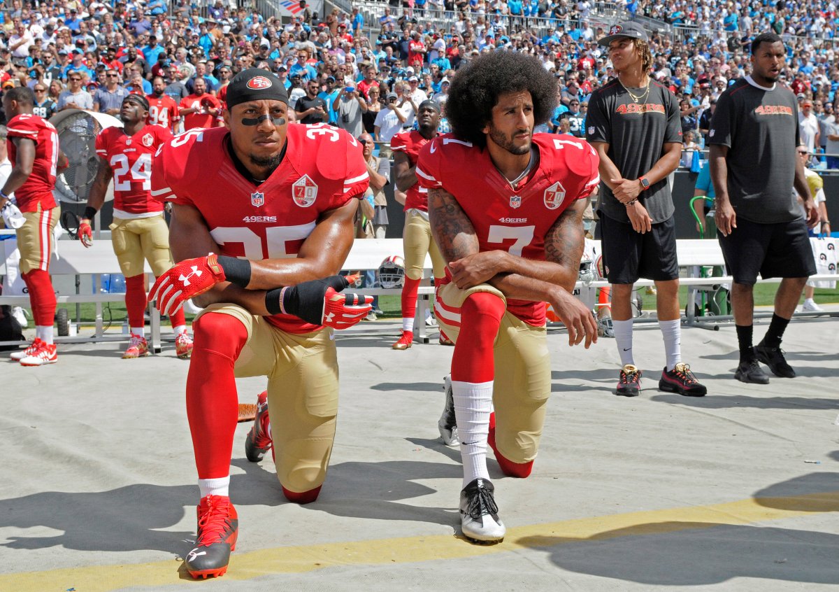 FILE - In this Sept. 18, 2016, file photo, San Francisco 49ers' Colin Kaepernick (7) and Eric Reid (35) kneel during the national anthem before an NFL football game against the Carolina Panthers, in Charlotte, N.C.