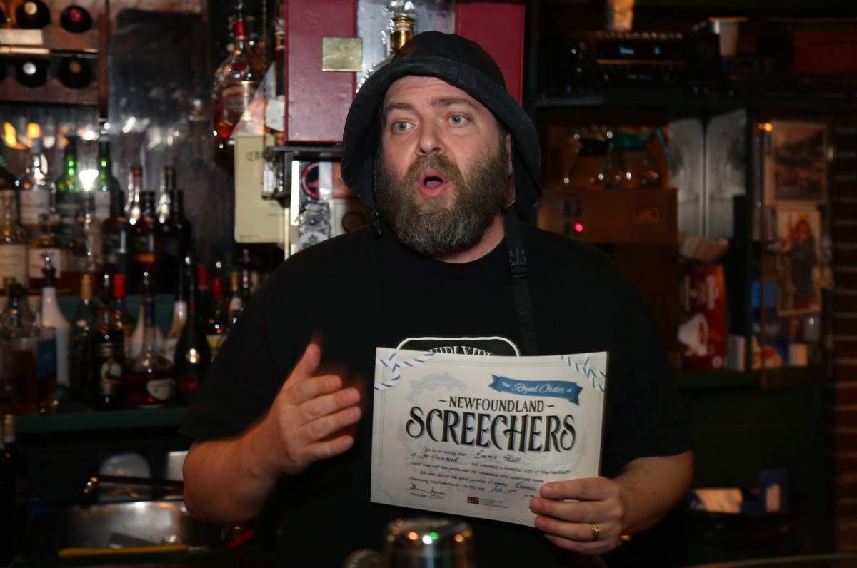 Brian Day displays the official certificate that participants receive as he officiates a “ScreechedIn” ceremony at Christian’s Pub on Wednesday February 13, 2019 in St. John’s, NL.