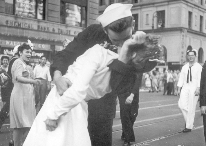 In this Aug. 14, 1945 file photo provided by the U.S. Navy, a sailor and a woman kiss in New York's Times Square, as people celebrate the end of World War II. 