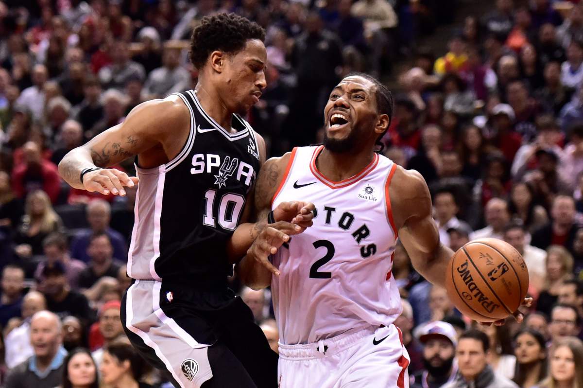 Toronto Raptors forward Kawhi Leonard (2) tries to get pass San Antonio Spurs guard DeMar DeRozan (10) during second half NBA basketball action in Toronto on Friday, Feb. 22, 2019. THE CANADIAN PRESS/Frank Gunn