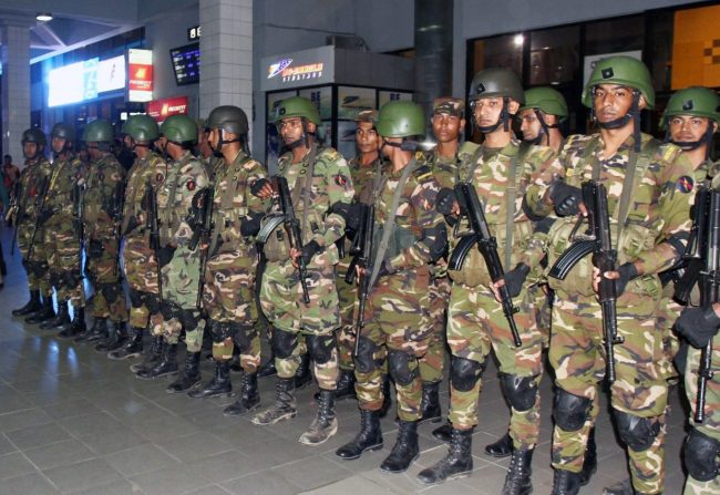Bangladeshi security forces stand guard at the Shah Amanat International Airport in Chattogram, Bangladesh, Feb. 24, 2019.