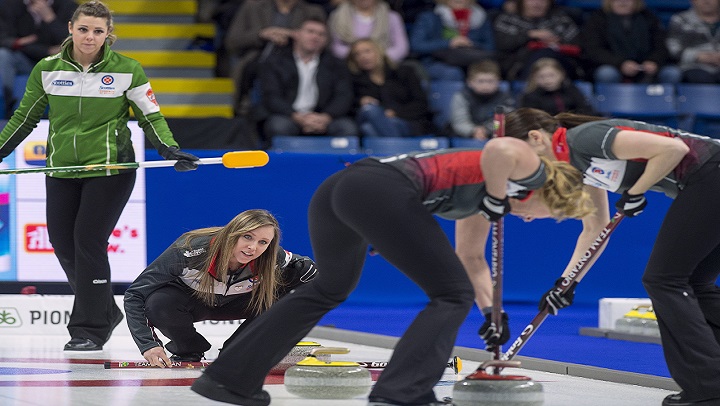 Saskatchewan skip Robyn Silvernagle, left, looks on as Ontario skip Rachel Homan, third Emma Miskew and lead Lisa Weagle, left to right, move a rock in semifinal action at the Scotties Tournament of Hearts at Centre 200 in Sydney, N.S., on Feb. 24, 2019.