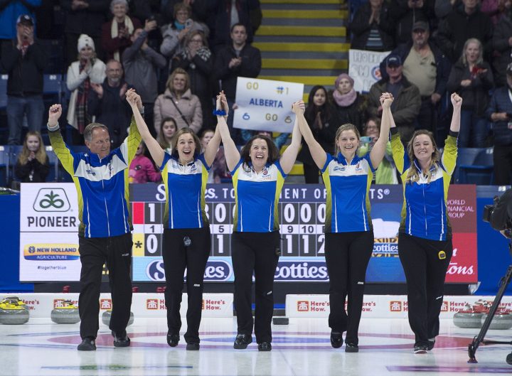 Alberta coach Dan Carey, lead Rachel Brown, second Dana Ferguson, third Sarah Wilkes and skip Chelsea, left to right, head down the sheet after defeating Ontario 8-6 to win the Scotties Tournament of Hearts at Centre 200 in Sydney, N.S., on Sunday, Feb. 24, 2019.