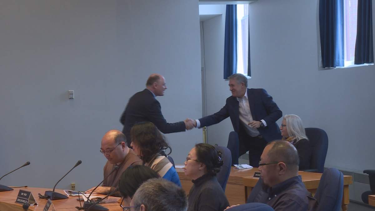 Trevor Holder and Mike O’Brien shake hands after the minister’s speech.
