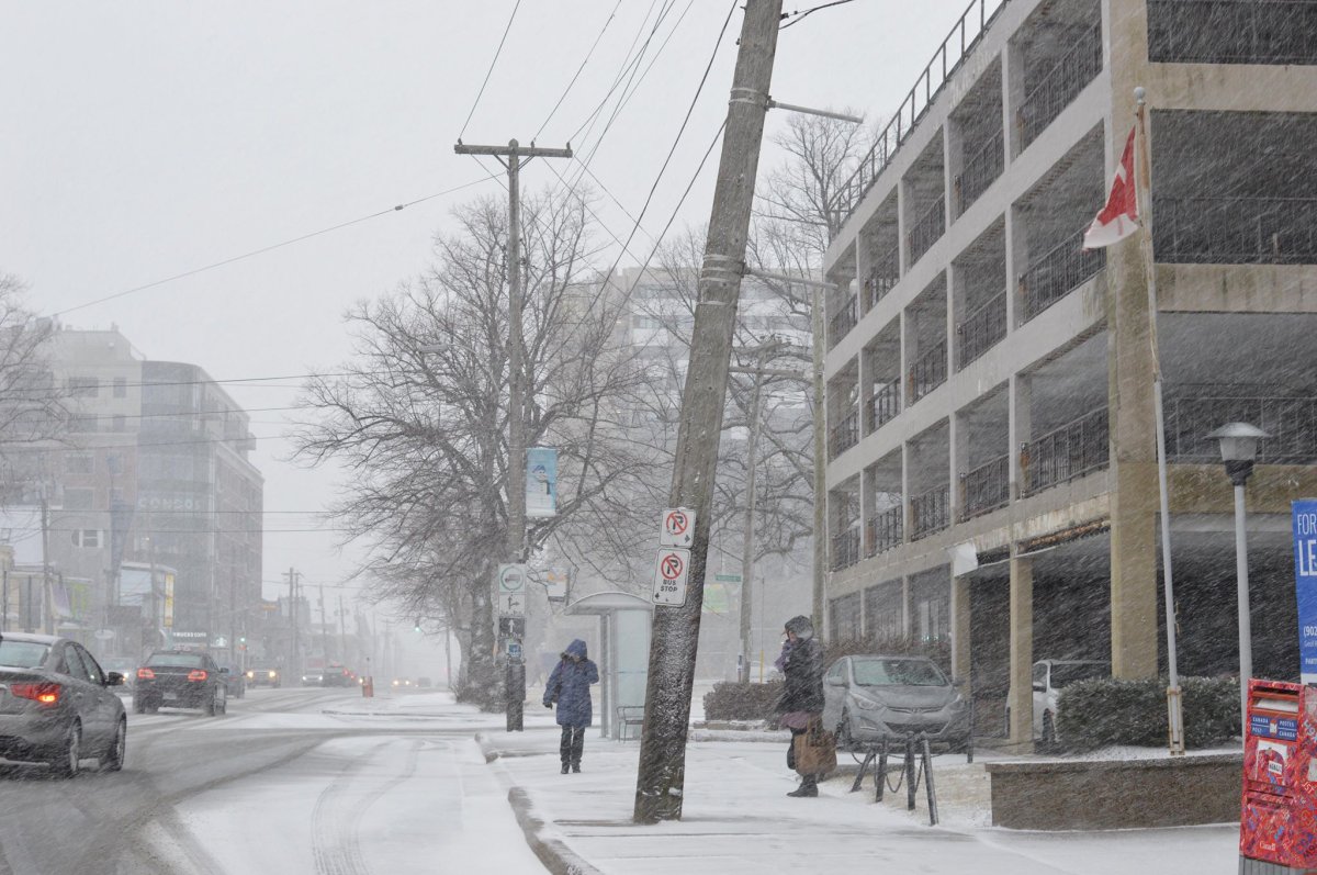 Pedestrians make their way down Quinpool Road in Halifax during a mid-January winter storm.