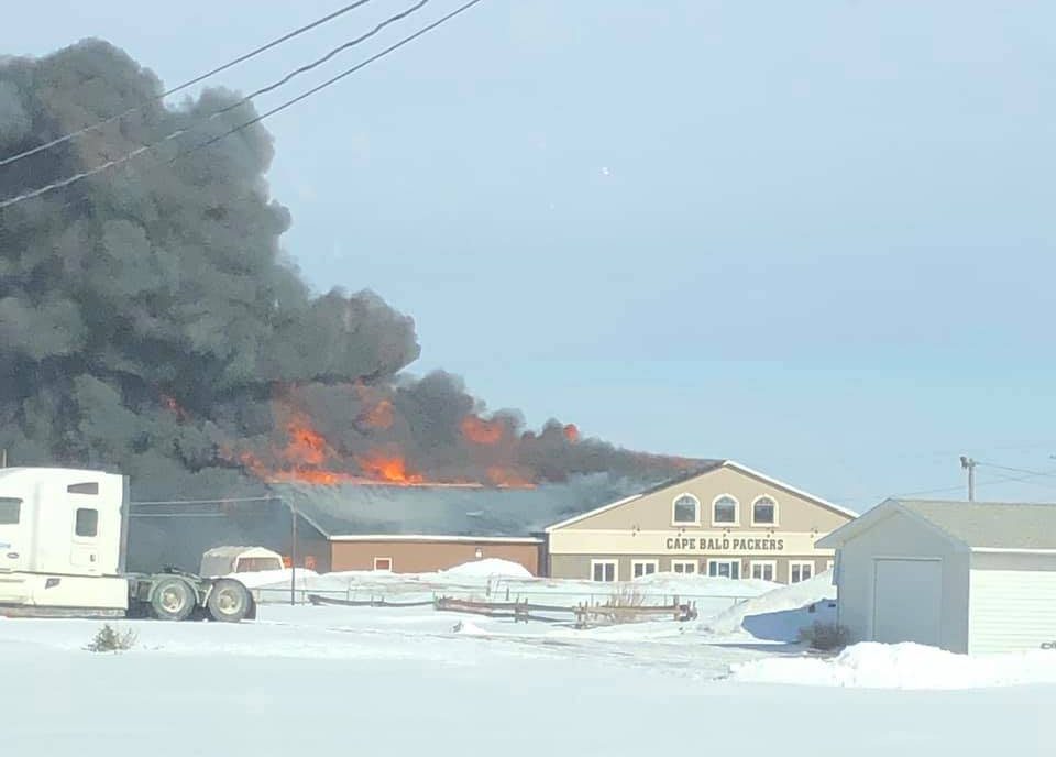 The Village of Cap-Pelé, N.B., is asking for citizens to avoid all non-essential travel as emergency crews battle a blaze at the Cape Bold Packers fish packing plant. 