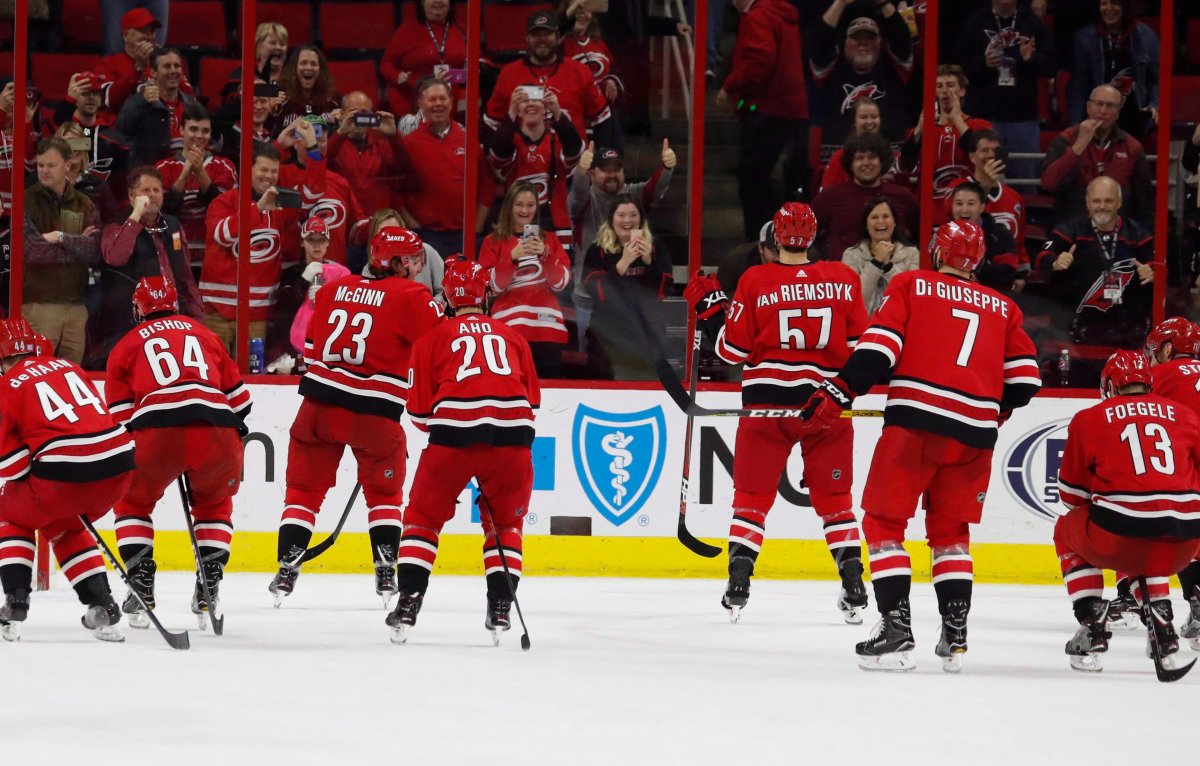 Carolina Hurricanes skate toward the crowd during an on ice celebration following their 2-1 win over the New Jersey Devils at an NHL hockey game, Sunday, Nov. 18, 2018, in Raleigh, N.C. Don Cherry's latest rant about the Carolina Hurricanes and their victory celebrations didn't go unnoticed by the NHL club. They've even decided to embrace his words. 