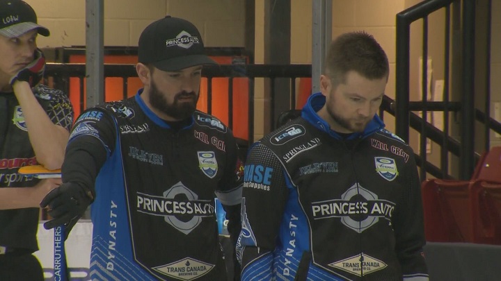 Reid Carruthers and Mike McEwen look over their options during a draw six loss to Brandon's Terry McNamee on Thursday in Virden.