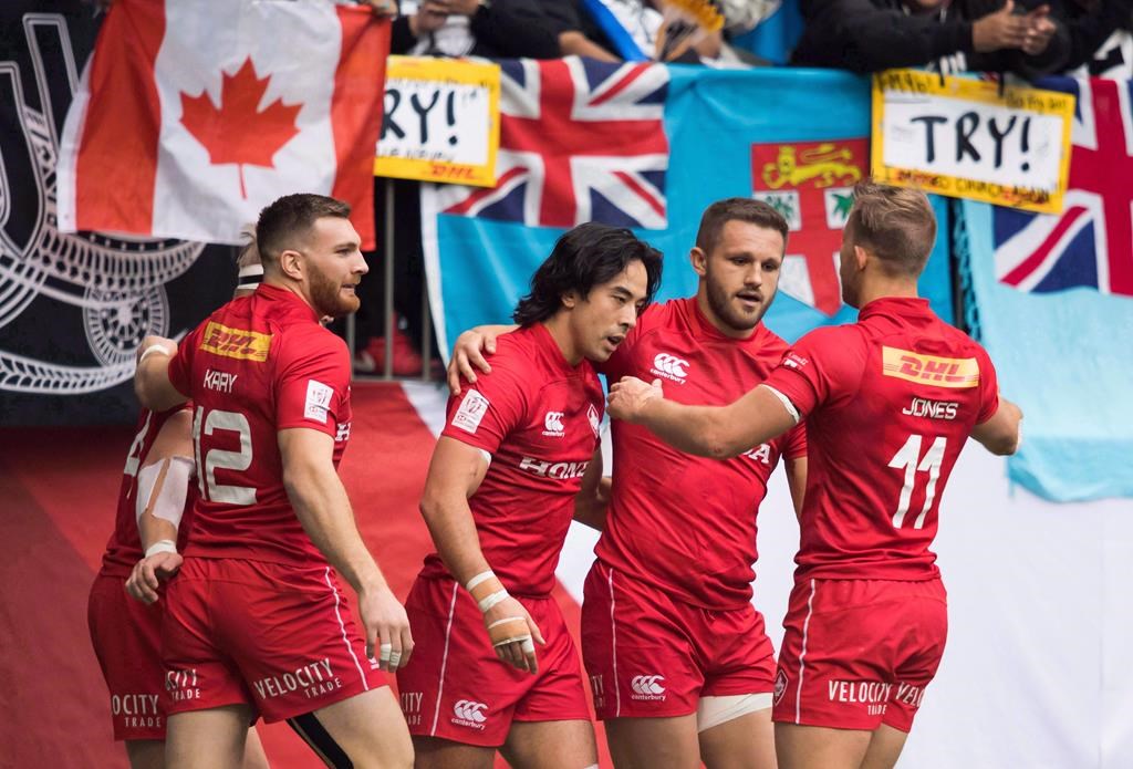Canada's Nathan Hirayama, centre, celebrates with his teammates after scoring a try against France during World Rugby Sevens Series action, in Vancouver, B.C., on March 11, 2018.